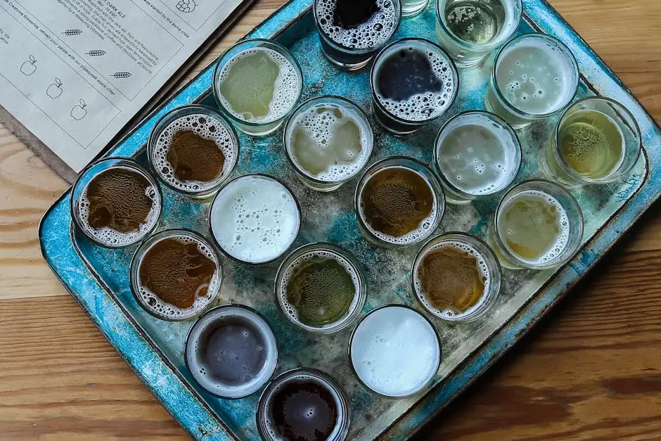 Aerial view of assorted glasses on a rustic tray, perfect for brewery tasting sessions.